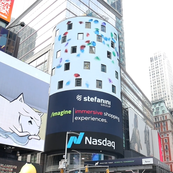 A view of the Times square Nasdaq building with a video of diamonds falling.